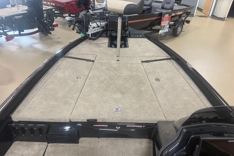 Slide: The Image of 2027 Phoenix 721 ZXL boat interior with carpeted deck and seating. - 10