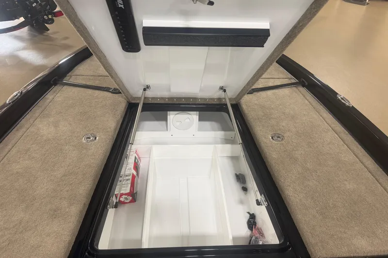 Slide: The Image of Open storage compartment in a 2027 Phoenix 721 ZXL boat, showcasing interior space. - 11