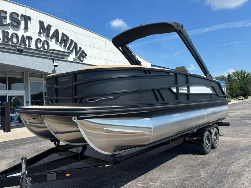 Slide: The Image of The image shows a modern pontoon boat on a trailer in front of a building. It features a sleek black design with silver accents. - 3
