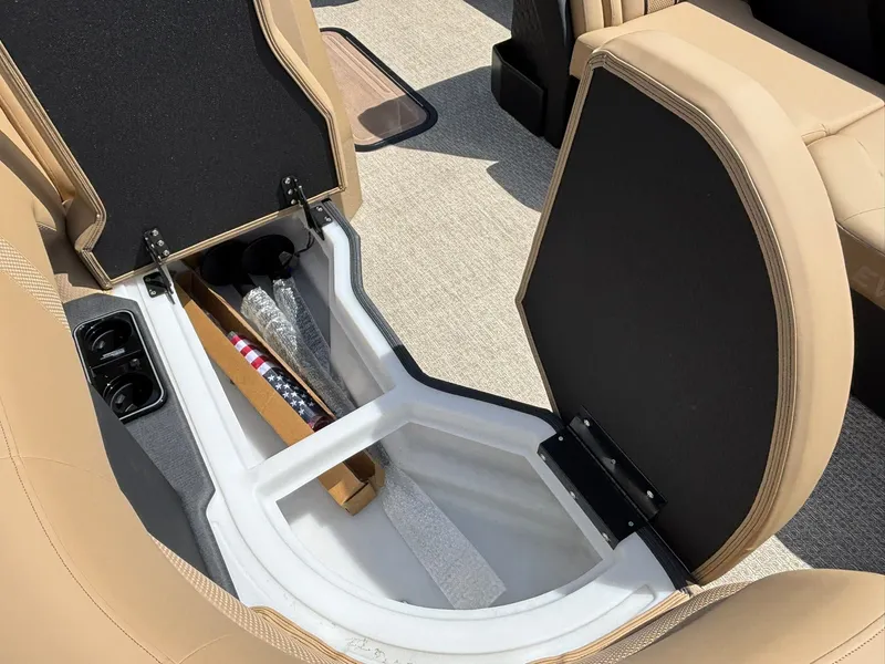 Slide: The Image of An open storage compartment in a boat with beige upholstery and carpeted flooring. - 10