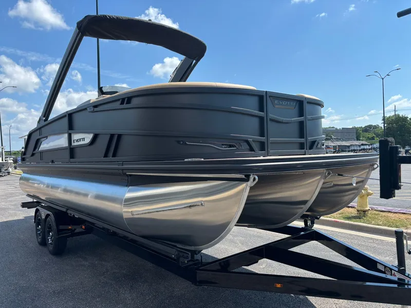 Slide: The Image of The image shows a modern pontoon boat on a trailer. It features a sleek design and black trim. - 4
