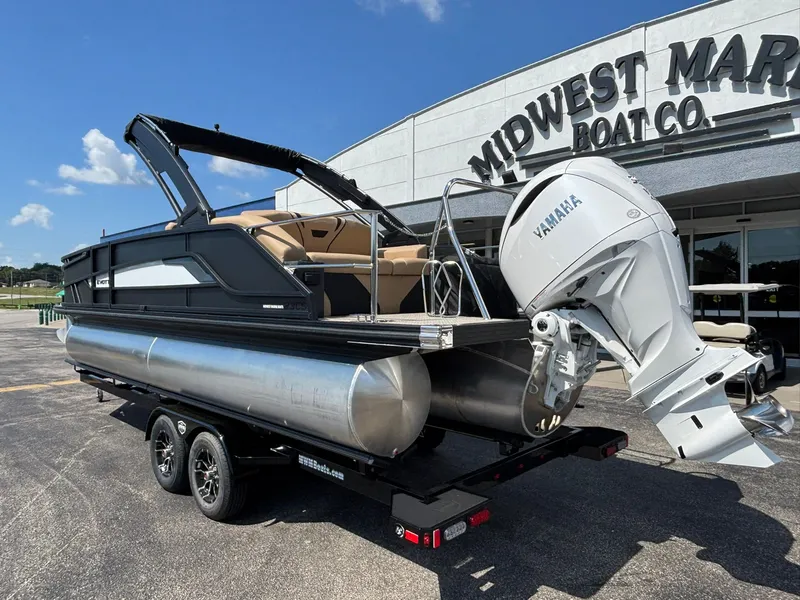 Slide: The Image of A 2027 Evotti 723 CS pontoon boat on a trailer outside a boat company building. - 8