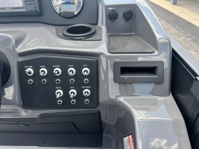 Slide: The Image of The image shows the dashboard of an Evotti 521 QL boat with various switches and gauges. - 23