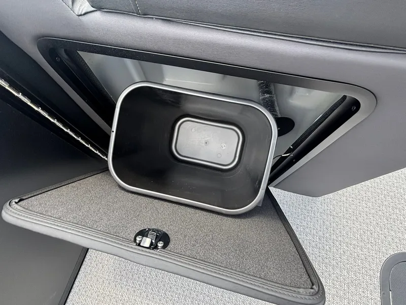 Slide: The Image of A black container in a compartment of a 2027 Evotti 521 QL boat. - 18