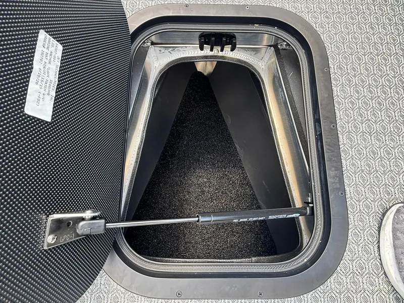 Slide: The Image of Evotti 521 QL 2027: Open storage compartment with carpeted interior and gas strut. - 15