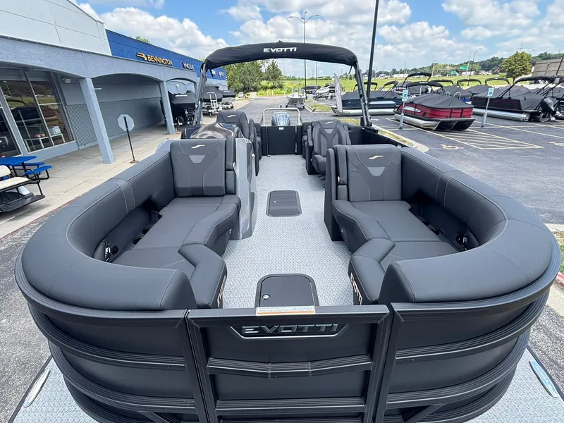 Slide: The Image of The image shows a modern pontoon boat with gray seating and a sleek design. - 9
