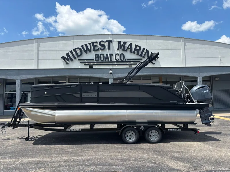 The Image of Evotti 521 QL pontoon boat parked in front of a boat company. - 1