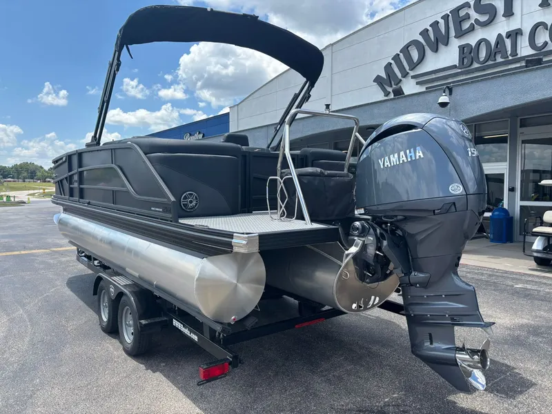 Slide: The Image of Evotti 521 QL 2027: Sleek pontoon boat with Yamaha outboard motor, on a trailer outside a boathouse. - 8