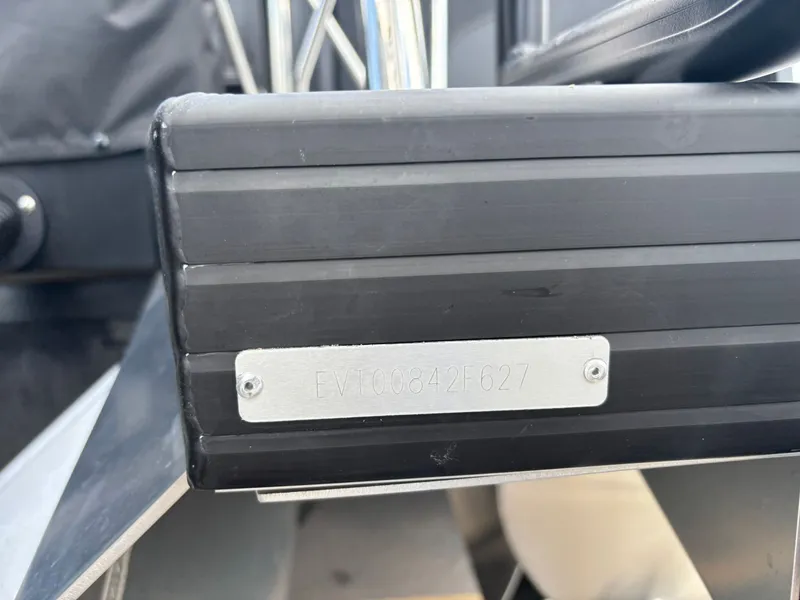 Slide: The Image of Close-up of a boat part with a metal plaque displaying the serial number. - 33