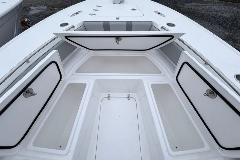 Slide: The Image of 2026 Cape Horn 28XS boat storage compartments open on deck. - 14