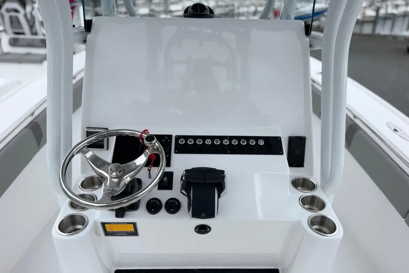 Slide: The Image of Steering console of 2026 Cape Horn 28XS boat with modern controls and cup holders. - 11