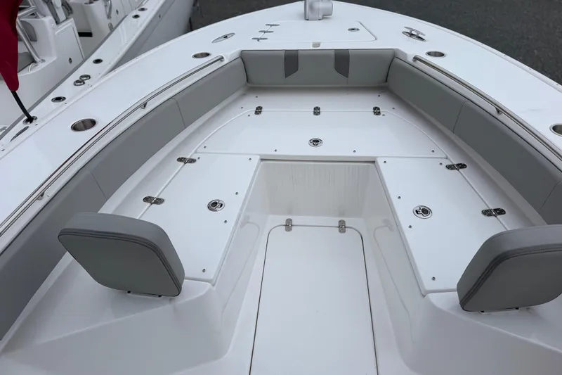 Slide: The Image of 2026 Cape Horn 28XS boat interior with cushioned seating and storage compartments. - 17