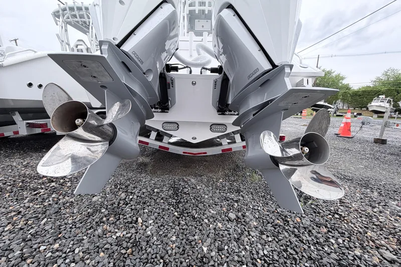 Slide: The Image of 2026 Cape Horn 28XS boat with dual outboard engines on a gravel lot. - 4