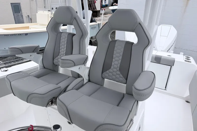 Slide: The Image of 2026 Cape Horn 28XS boat seats with gray upholstery and armrests. - 9