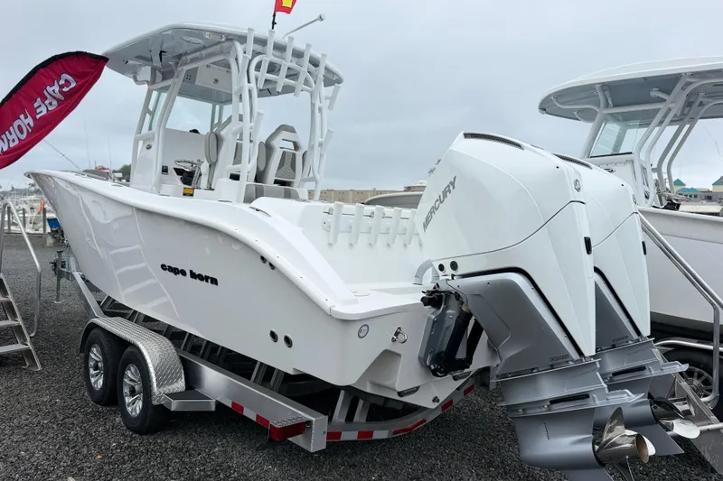 Slide: The Image of 2026 Cape Horn 28XS boat with dual Mercury engines on a trailer. - 1