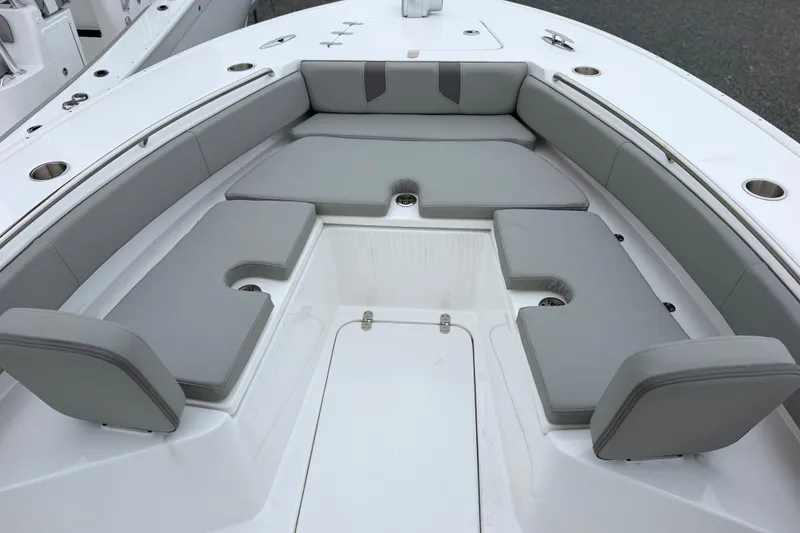Slide: The Image of 2026 Cape Horn 28XS boat interior with gray cushioned seating and cup holders. - 15
