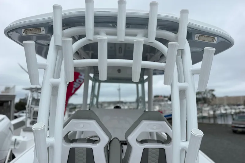 Slide: The Image of 2026 Cape Horn 28XS boat with rod holders and seating, docked at marina. - 9