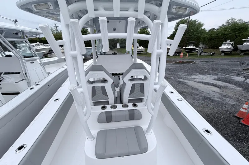 Slide: The Image of 2026 Cape Horn 28XS boat interior with seating and rod holders, docked outdoors. - 6