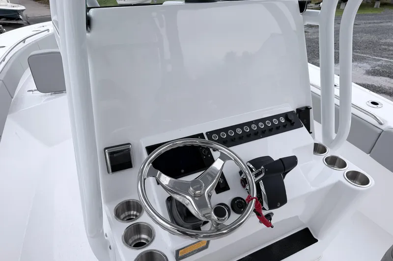 Slide: The Image of Steering console of 2026 Cape Horn 28XS boat with modern controls and cup holders. - 8