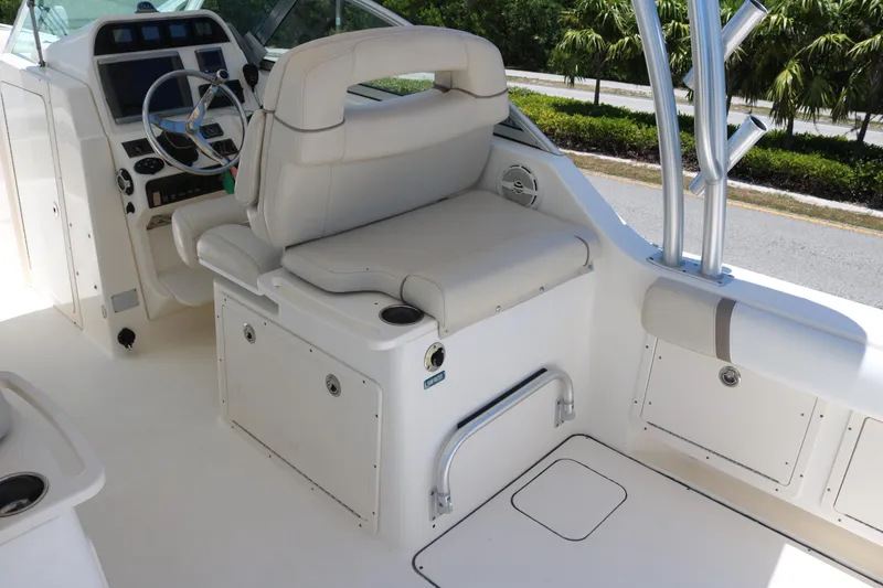 Slide: The Image of 2014 World Cat 295 DC boat interior with helm, seating, and storage compartments. - 7