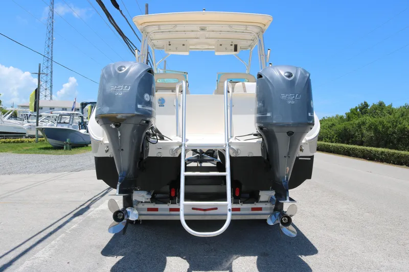 Slide: The Image of 2014 World Cat 295 DC boat with dual Yamaha 250 engines, rear view. - 3