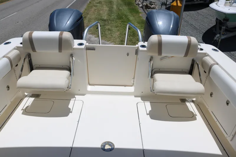 Slide: The Image of 2014 World Cat 295 DC boat interior with seating and dual engines. - 12