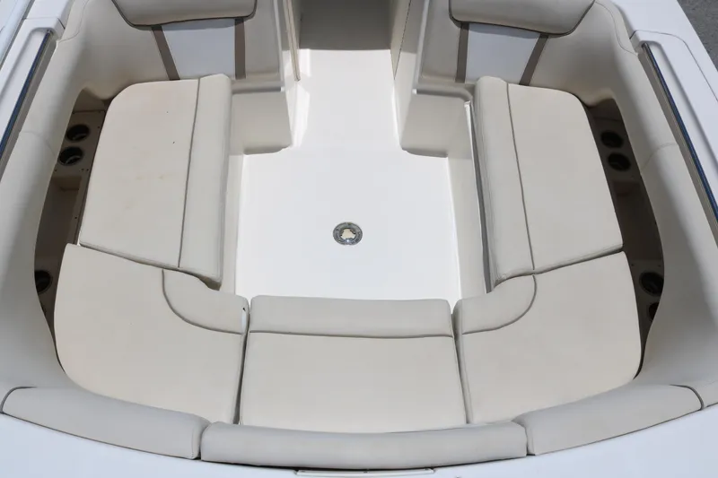 Slide: The Image of Spacious seating area on 2014 World Cat 295 DC boat, featuring comfortable beige cushions. - 4
