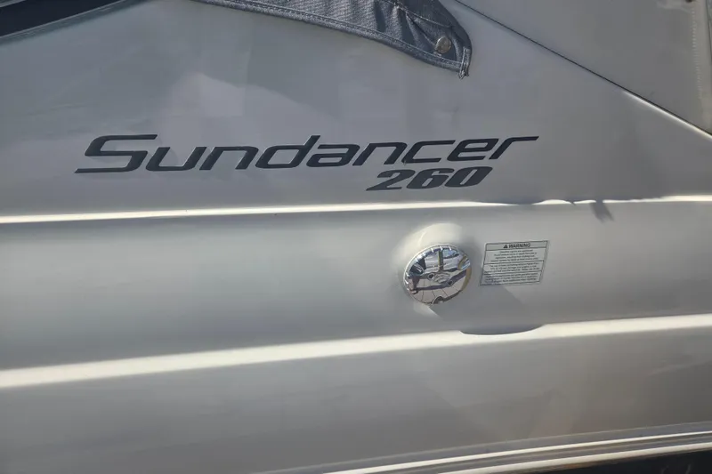 Slide: The Image of 2012 Sea Ray Sundancer 260 boat exterior with model name and warning label. - 19