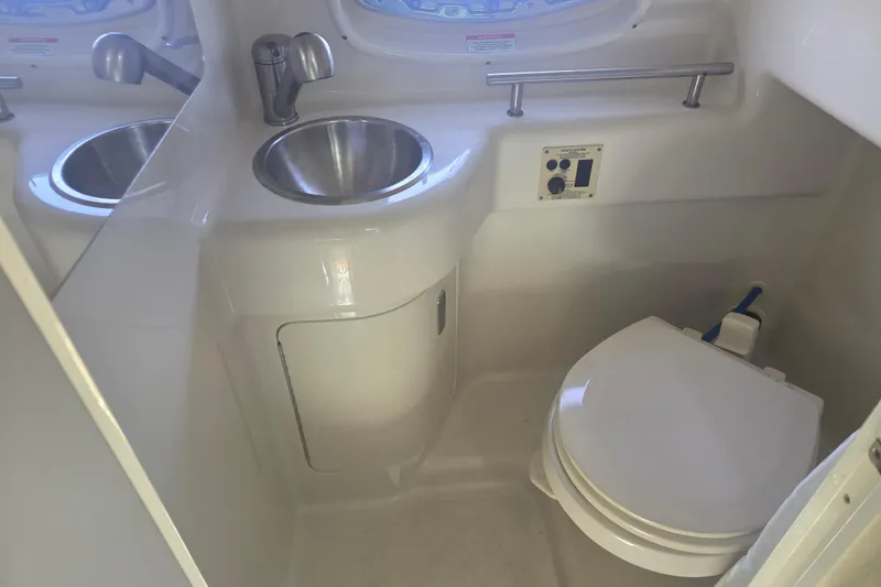 Slide: The Image of Interior of 2012 Sea Ray Sundancer 260 boat bathroom with sink and toilet. - 16