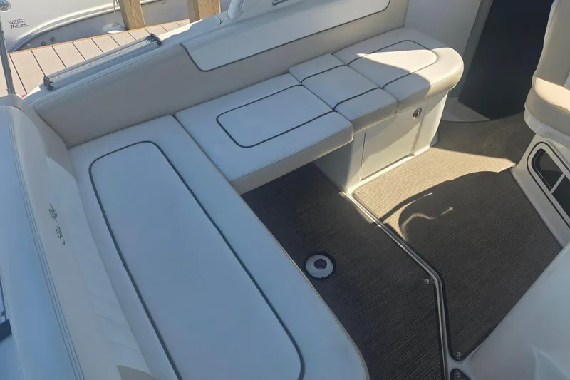 Slide: The Image of Interior seating of 2012 Sea Ray Sundancer 260 boat with white upholstery. - 5