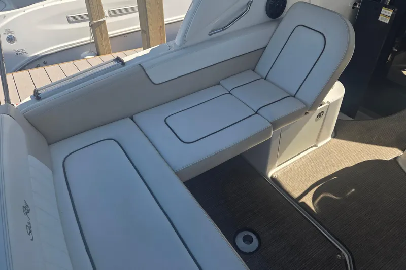 Slide: The Image of Interior seating of 2012 Sea Ray Sundancer 260 boat, featuring white cushioned seats. - 3