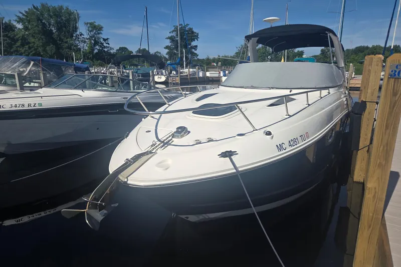 Slide: The Image of 2012 Sea Ray Sundancer 260 docked at marina under clear blue sky. - 22