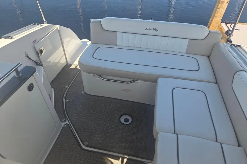 Slide: The Image of 2012 Sea Ray Sundancer 260 boat interior with cushioned seating and carpeted floor. - 12