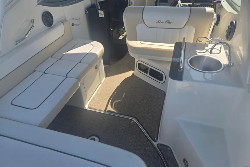 Slide: The Image of Interior of 2012 Sea Ray Sundancer 260 boat with seating and sink area. - 2
