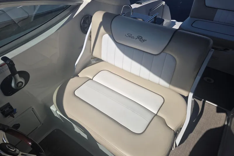 Slide: The Image of Interior seating of 2012 Sea Ray Sundancer 260 boat, featuring beige and white upholstery. - 11