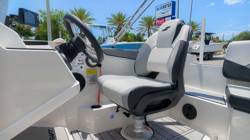 Slide: The Image of The image shows the helm of a Starcraft SV 18 OB with a comfortable seat and steering wheel. - 18