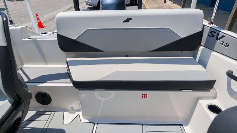 Slide: The Image of The 2027 Starcraft SV 18 OB features a gray bench seat with a black accent. - 7