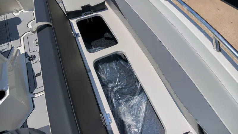 Slide: The Image of Interior view of a 2027 Starcraft SV 18 OB with storage compartments under the seats. - 12