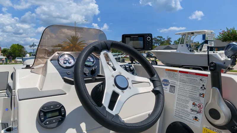 Slide: The Image of The image shows the helm of a Starcraft SV 18 OB boat with a steering wheel and instruments. - 17