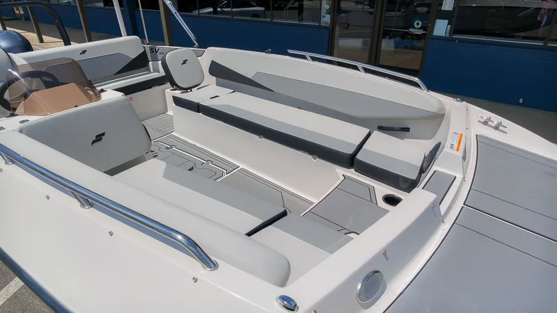 Slide: The Image of The image shows the spacious cockpit of a Starcraft SV 18 OB boat with gray upholstery. - 3