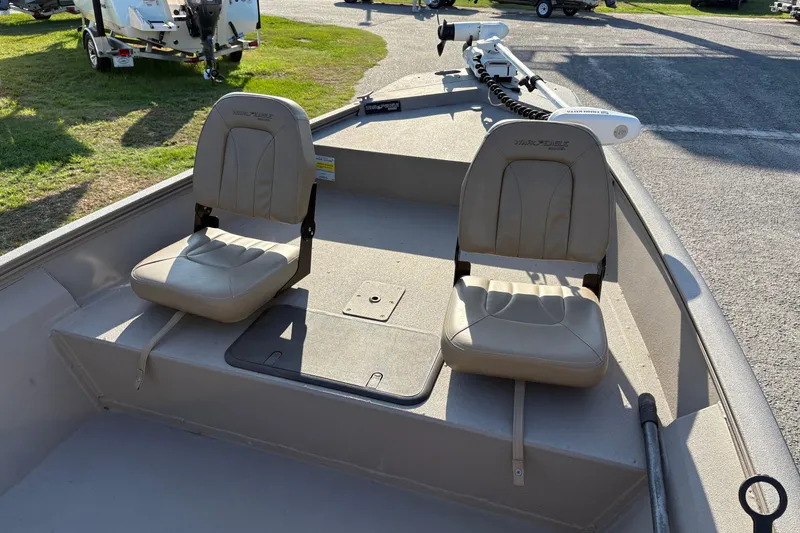 Slide: The Image of 2019 War Eagle 961 Blackhawk boat interior with two beige seats and trolling motor. - 13