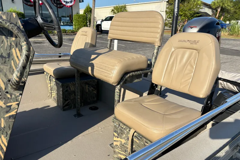 Slide: The Image of 2019 War Eagle 961 Blackhawk boat interior with beige seats and camouflage accents. - 8