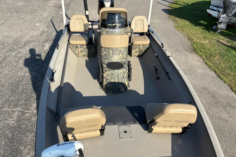 Slide: The Image of 2019 War Eagle 961 Blackhawk boat interior with seating and camouflage console. - 15