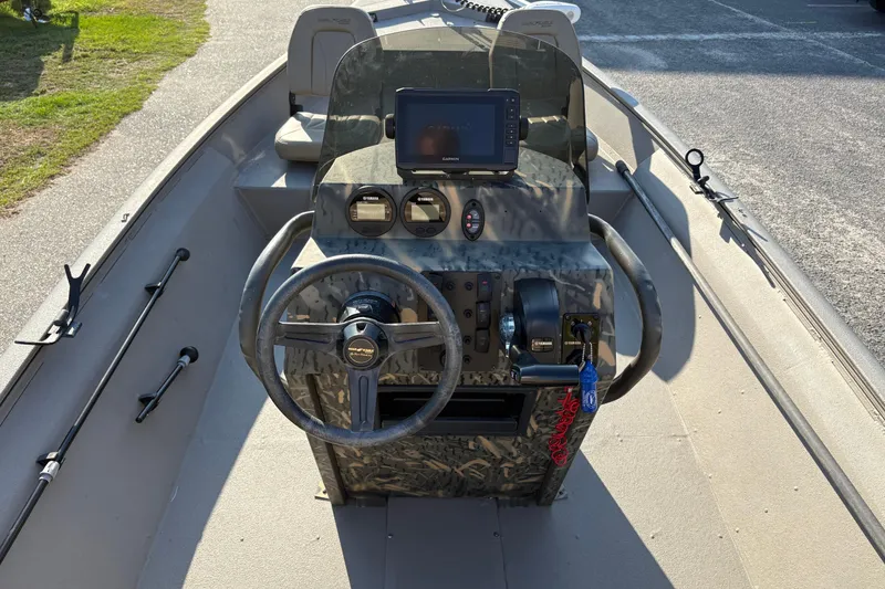 Slide: The Image of 2019 War Eagle 961 Blackhawk boat console with steering wheel and navigation equipment. - 9