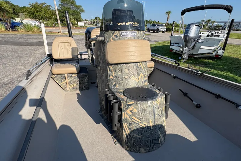 Slide: The Image of 2019 War Eagle 961 Blackhawk boat interior with camouflage console and seating. - 12