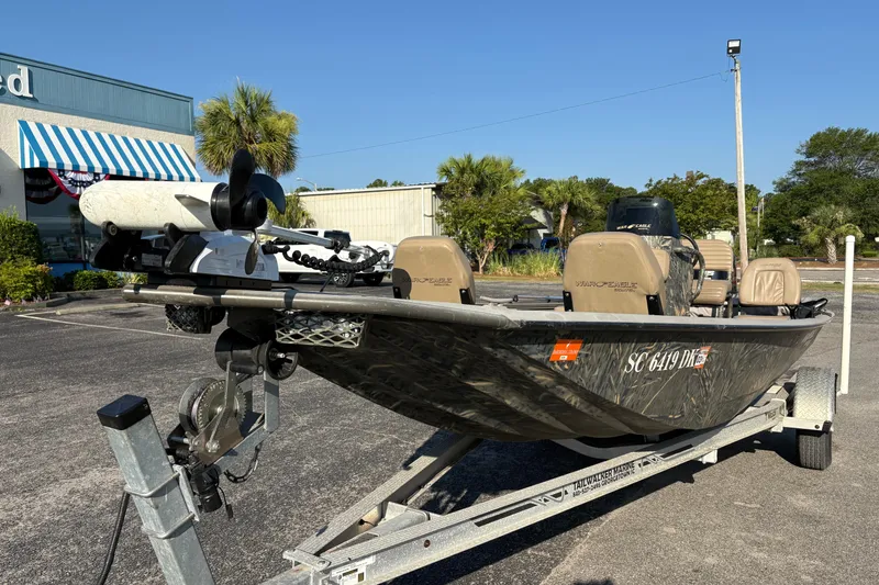 Slide: The Image of 2019 War Eagle 961 Blackhawk boat on trailer in parking lot. - 5
