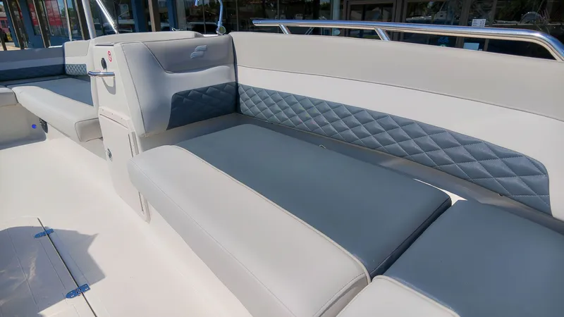 Slide: The Image of Interior view of a Starcraft SVX 211 OB boat with gray and white upholstery. - 13