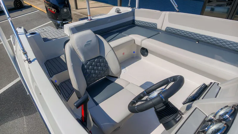 Slide: The Image of The image shows the cockpit of a Starcraft SVX 211 OB boat with gray seating and steering wheel. - 4