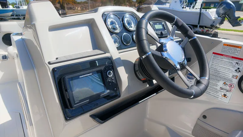 Slide: The Image of The image shows the helm of a Starcraft SVX 211 OB boat with modern instruments. - 20