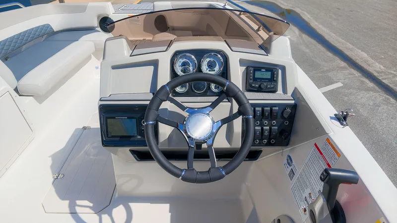 Slide: The Image of The image shows the cockpit of a Starcraft SVX 211 OB boat with a modern helm. - 19